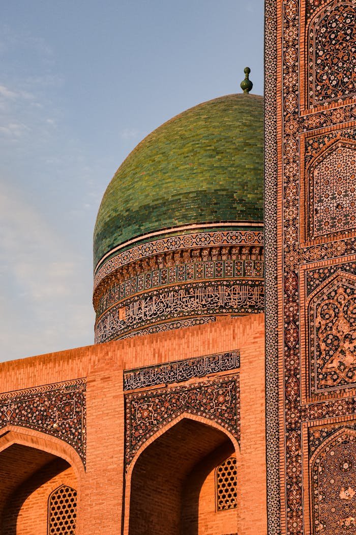 Close-up view of the intricate dome and mosaic of Mir-I-Arab Madrasa at sunset in Bukhara, Uzbekistan.