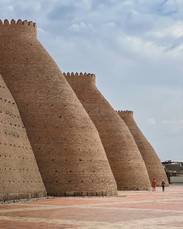 The majestic brick walls of the historic Ark Fortress in Bukhara, Uzbekistan on a clear day.